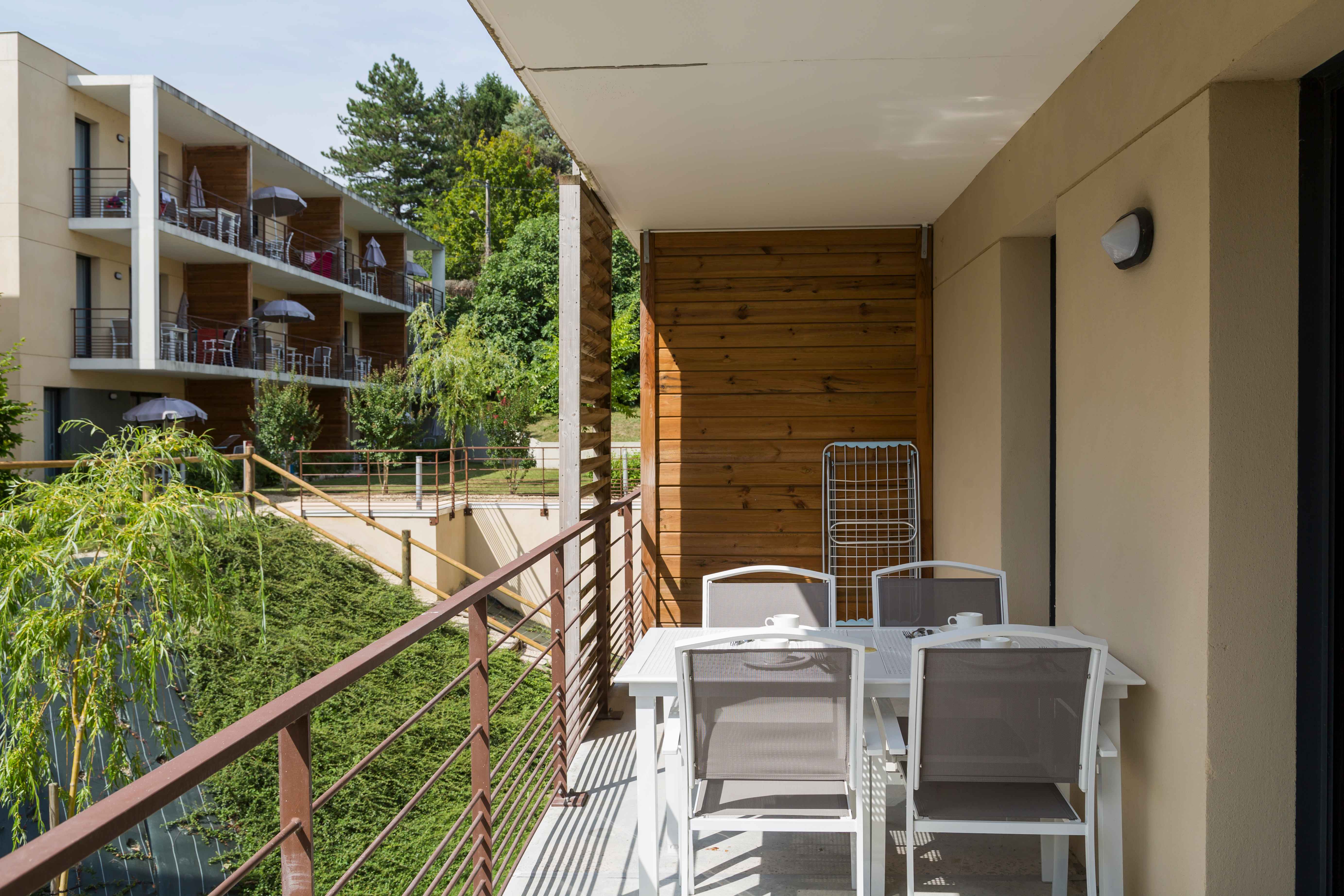 image Step out onto your private balcony and take in the greenery of the residence grounds — a quiet moment to savour before heading out to discover the best of Chinon.
