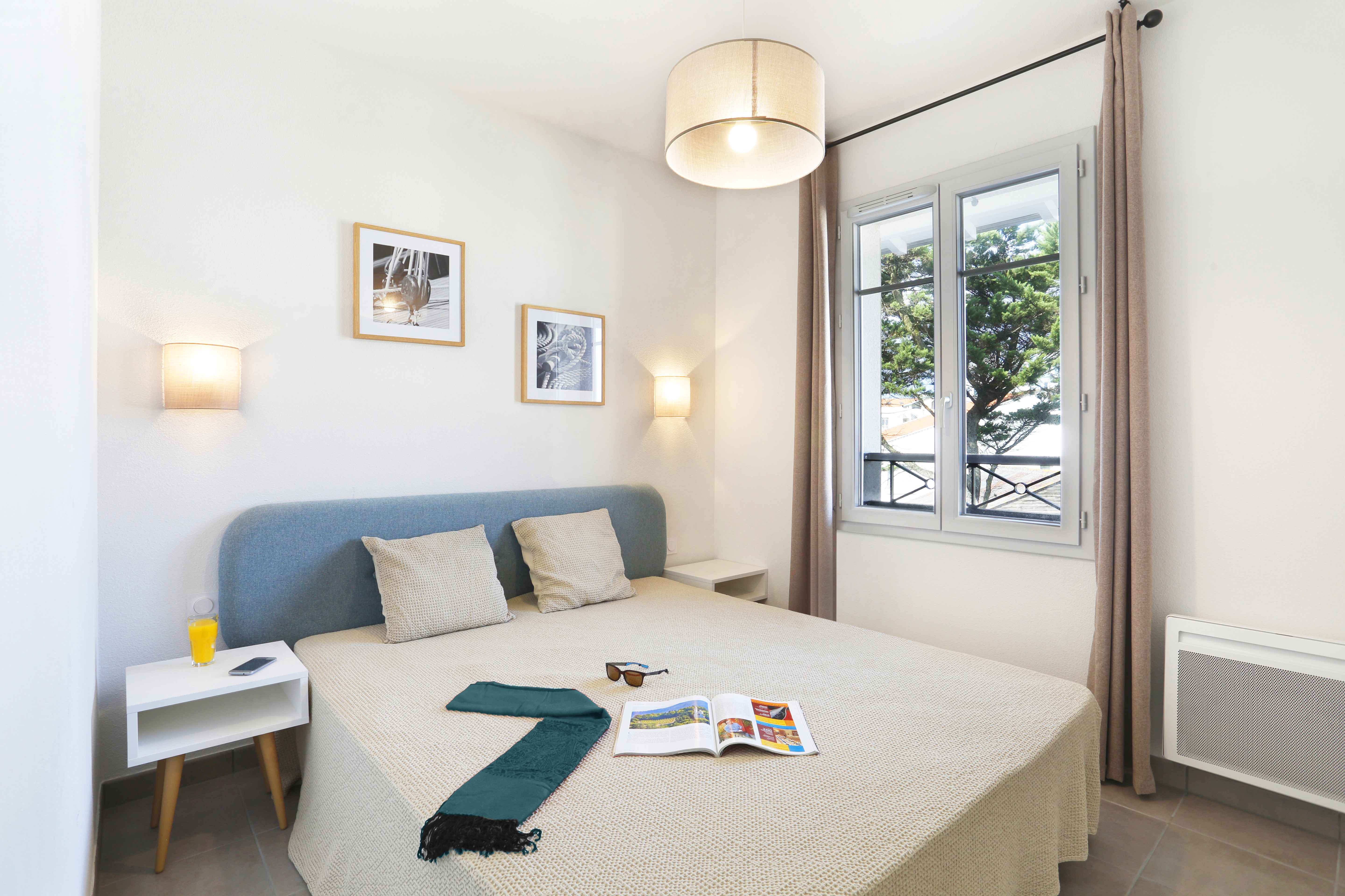 image Enjoy cozy moments in a bright bedroom, featuring inviting decor and natural light.