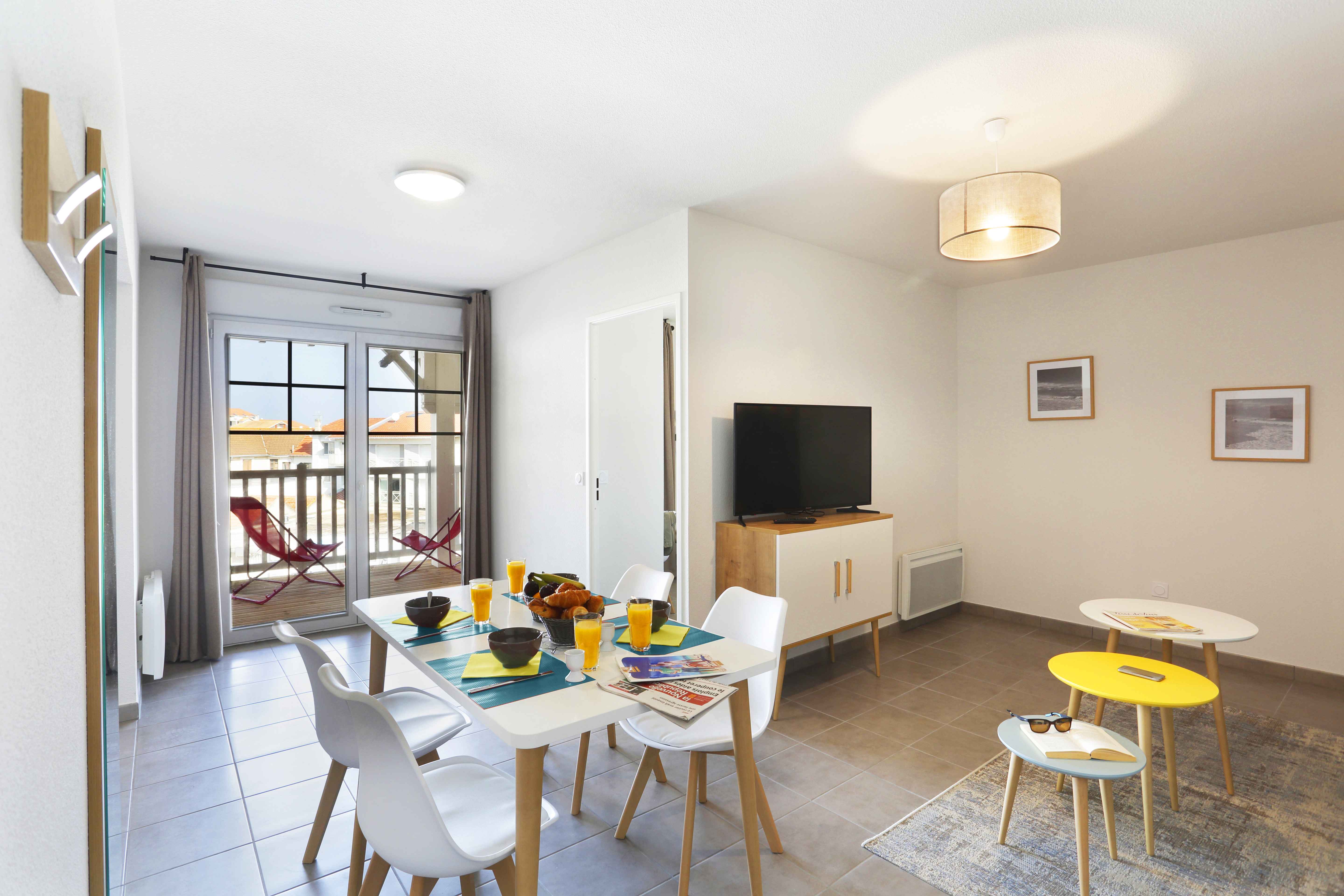 image Gather around the bright dining table, perfect for enjoying breakfast or planning your seaside adventures.