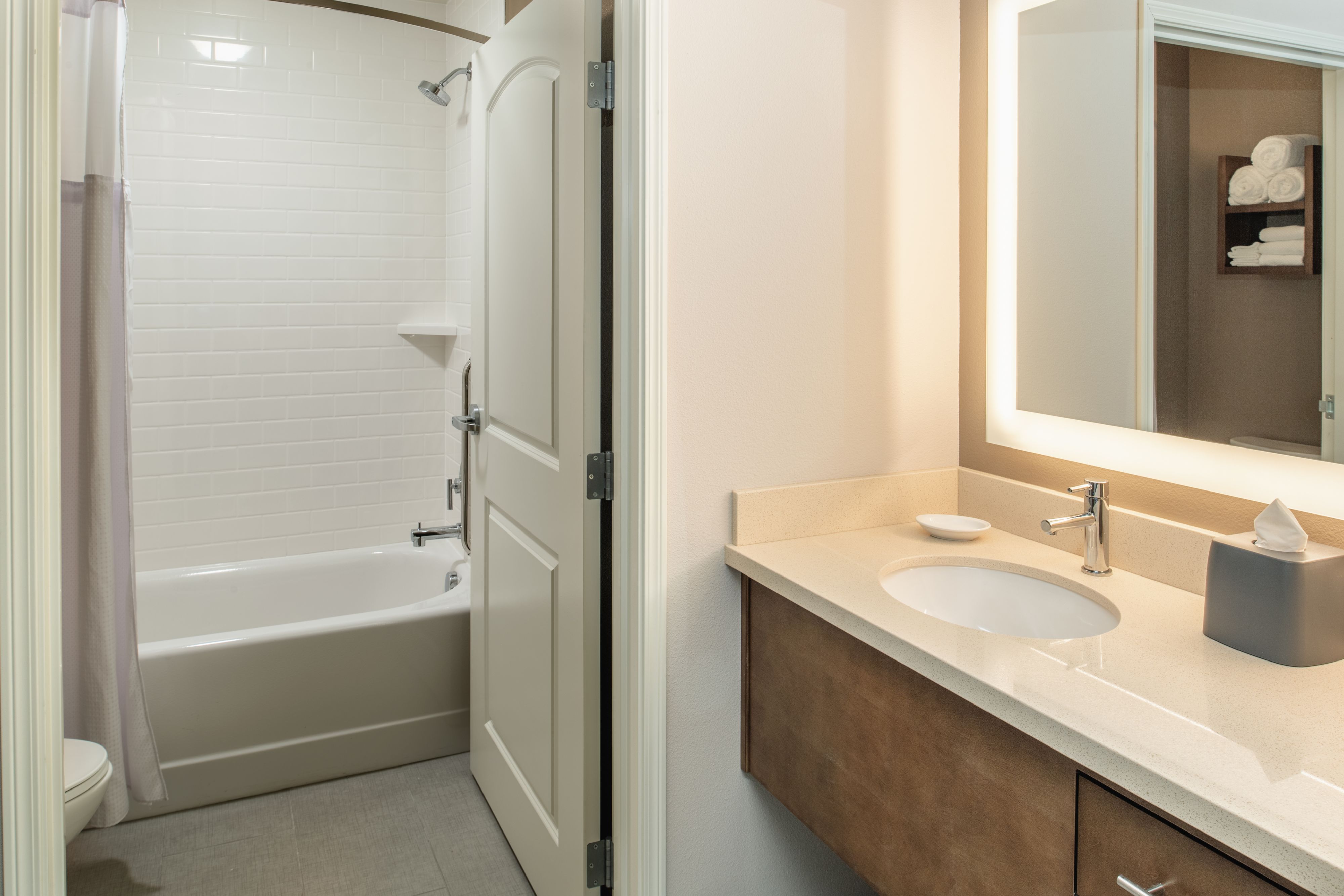 image Accessible bathroom with tub, grab bars, and visual alert system.