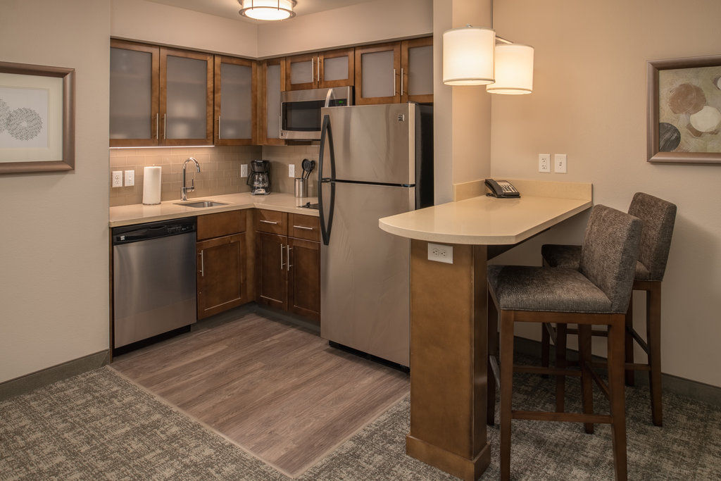 image Kitchen with modern appliances, cabinetry, and bar seating.