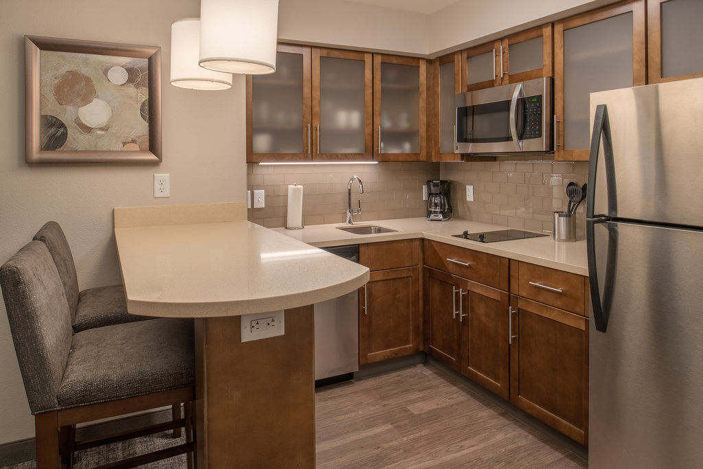 image Kitchen with modern appliances, cabinetry, and bar seating.