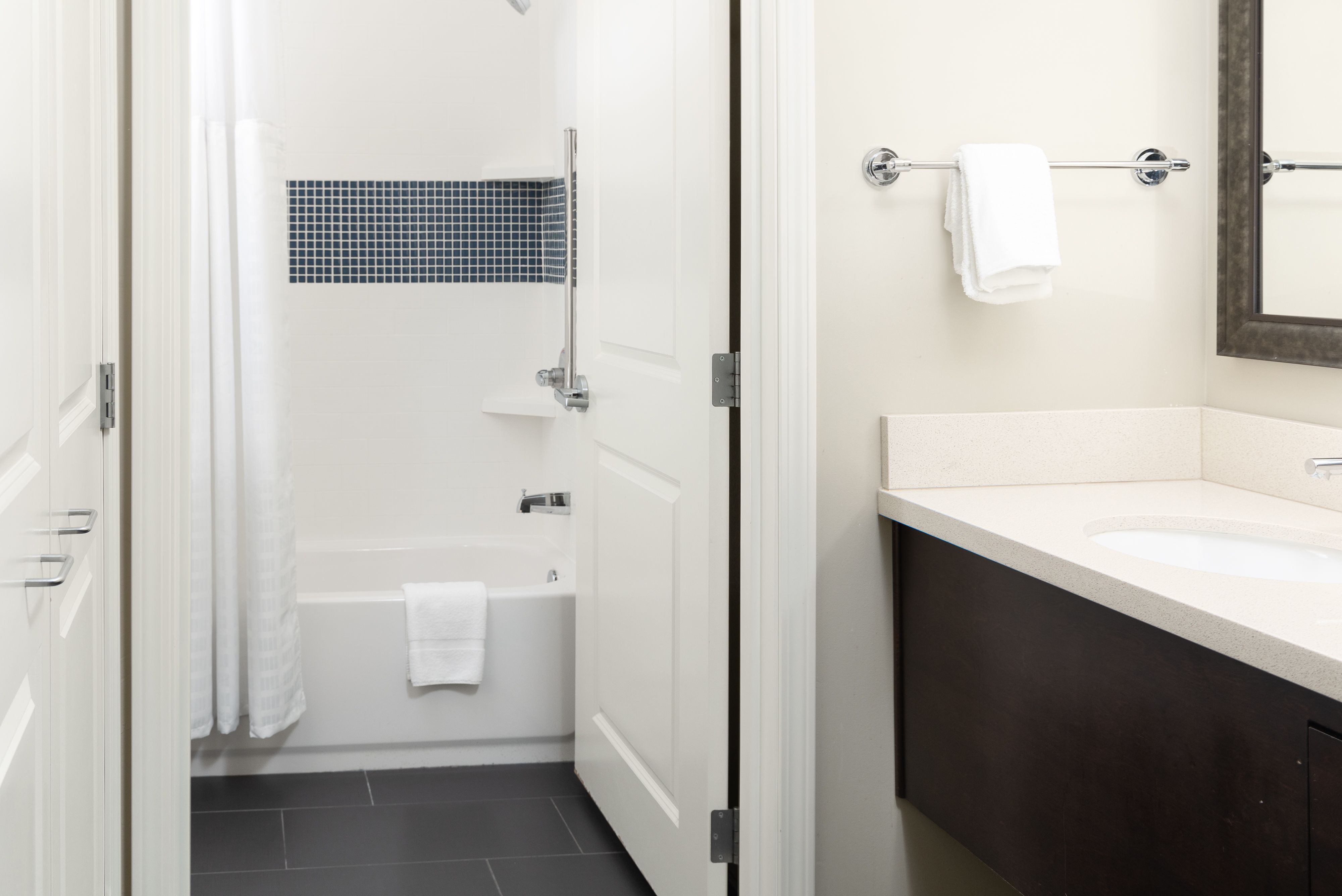 image Bathroom with a tub, shower curtain, and vanity.