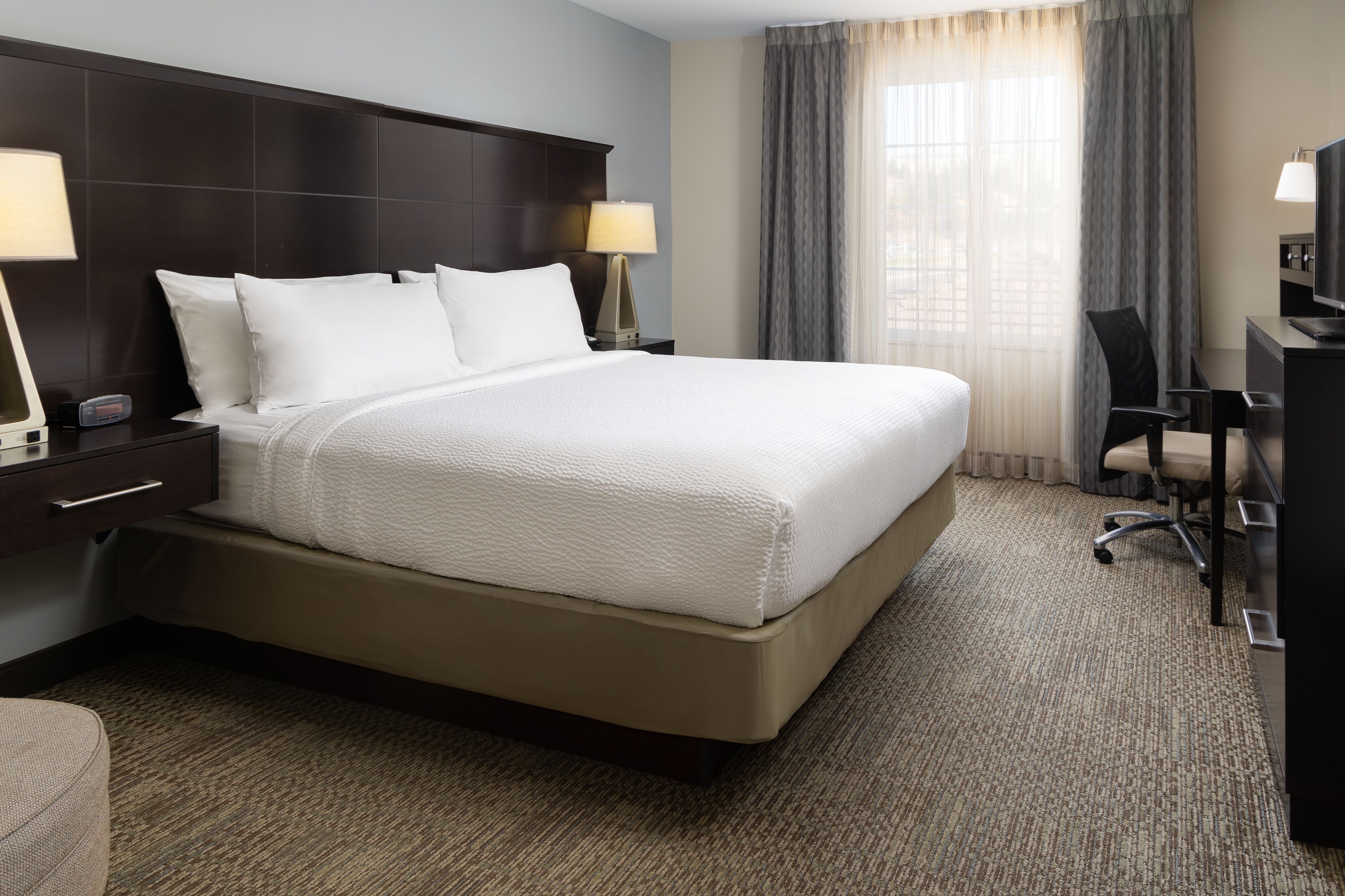image King bedroom with comfortable bed and workspace.