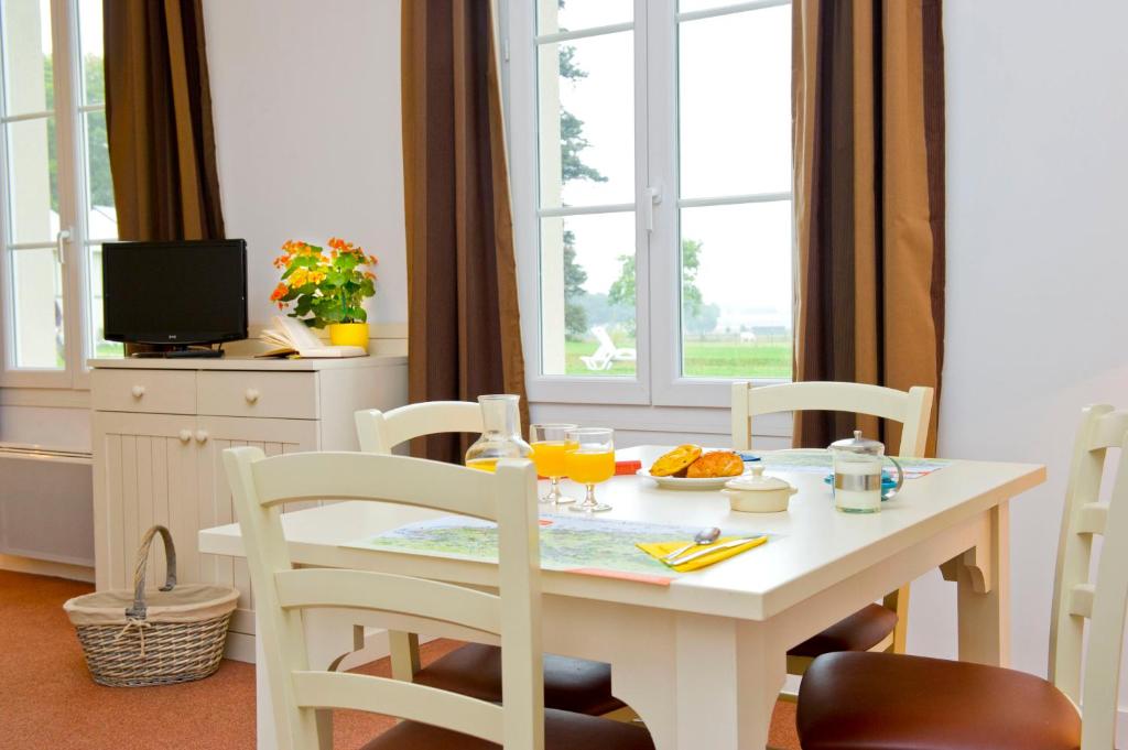 image Greet the morning sun through large windows, lush Norman greenery stretching out while your coffee brews