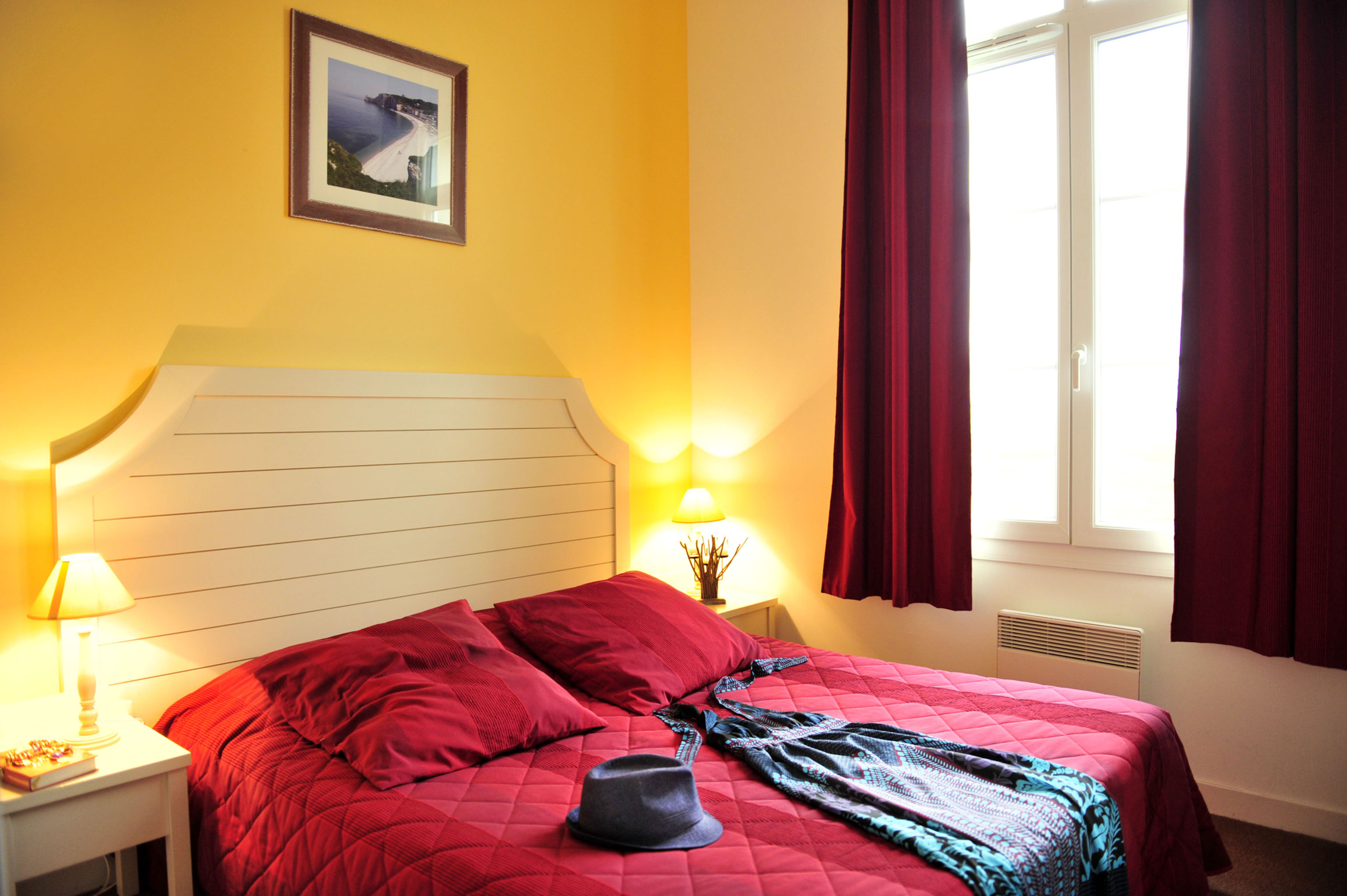 image The upper-level double bedroom has warm tones and a double bed — space for two after a day on the coast