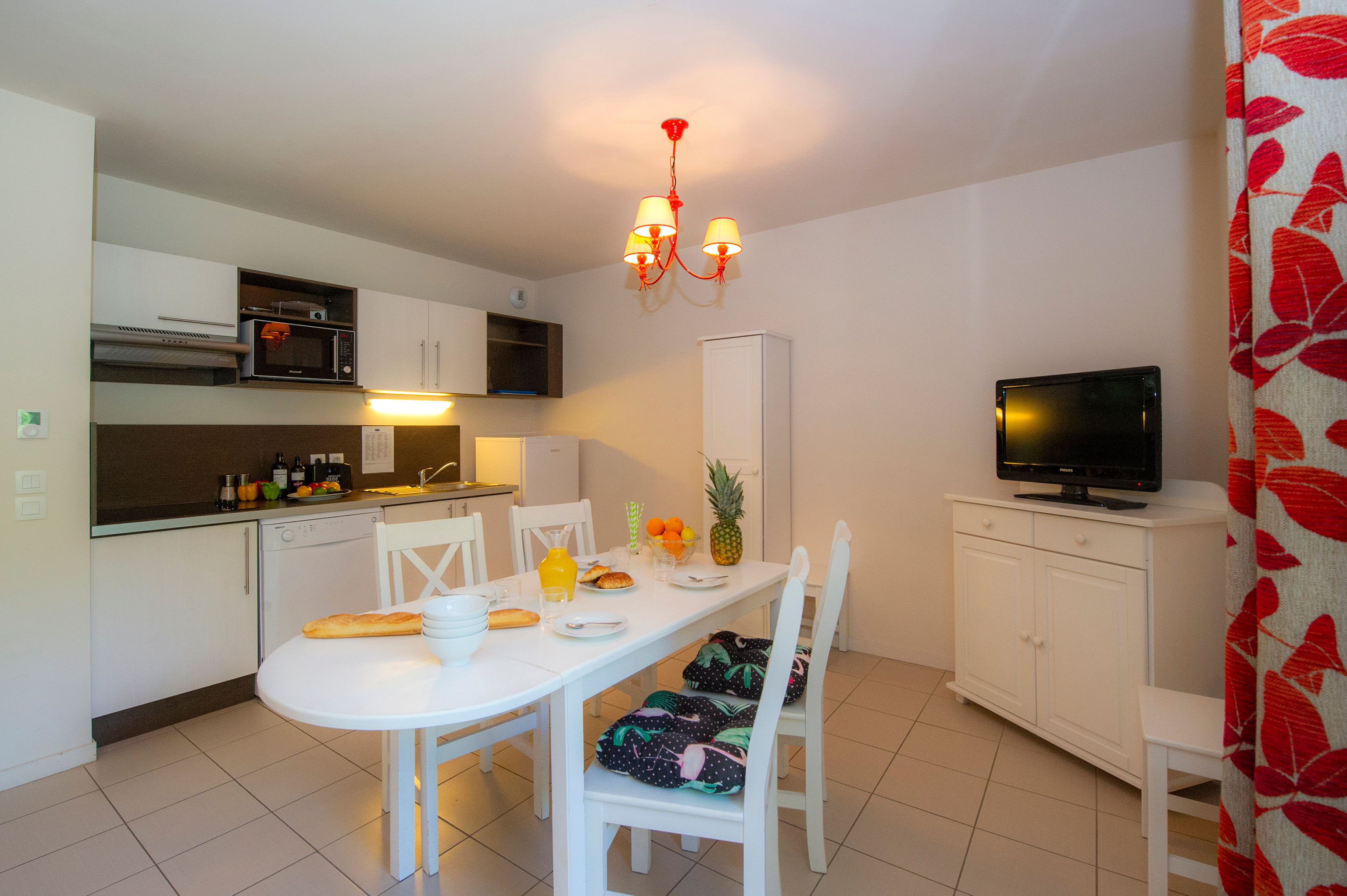 image Gather around the white dining table after a day at Honfleur's Vieux Bassin.