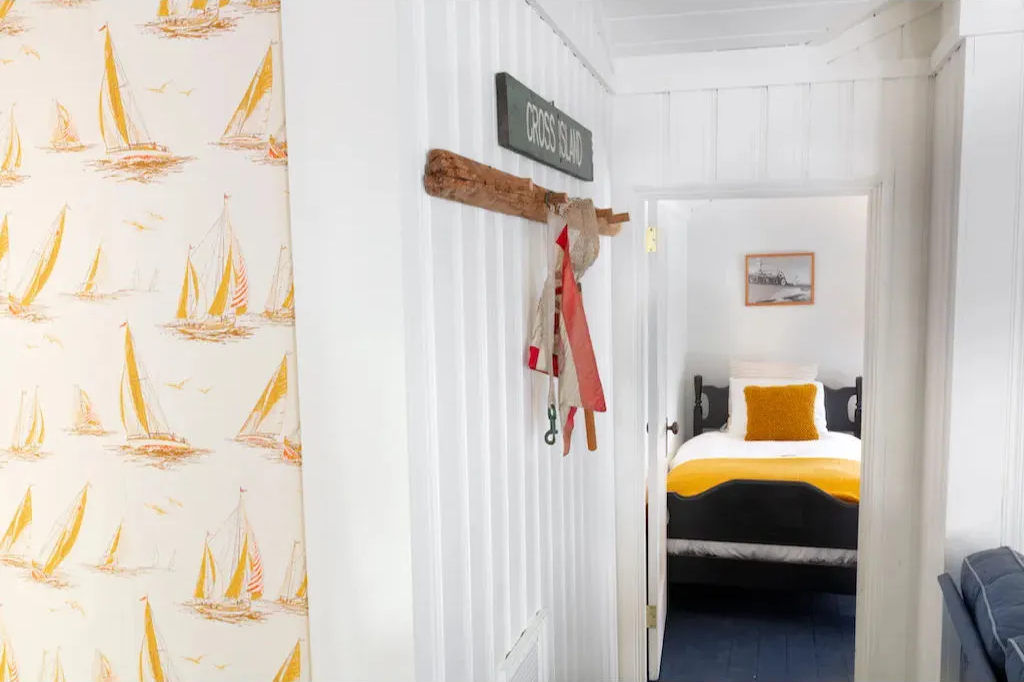 image Step into a playful coastal hideaway where cheerful prints and nautical nods set the tone for a carefree stay.