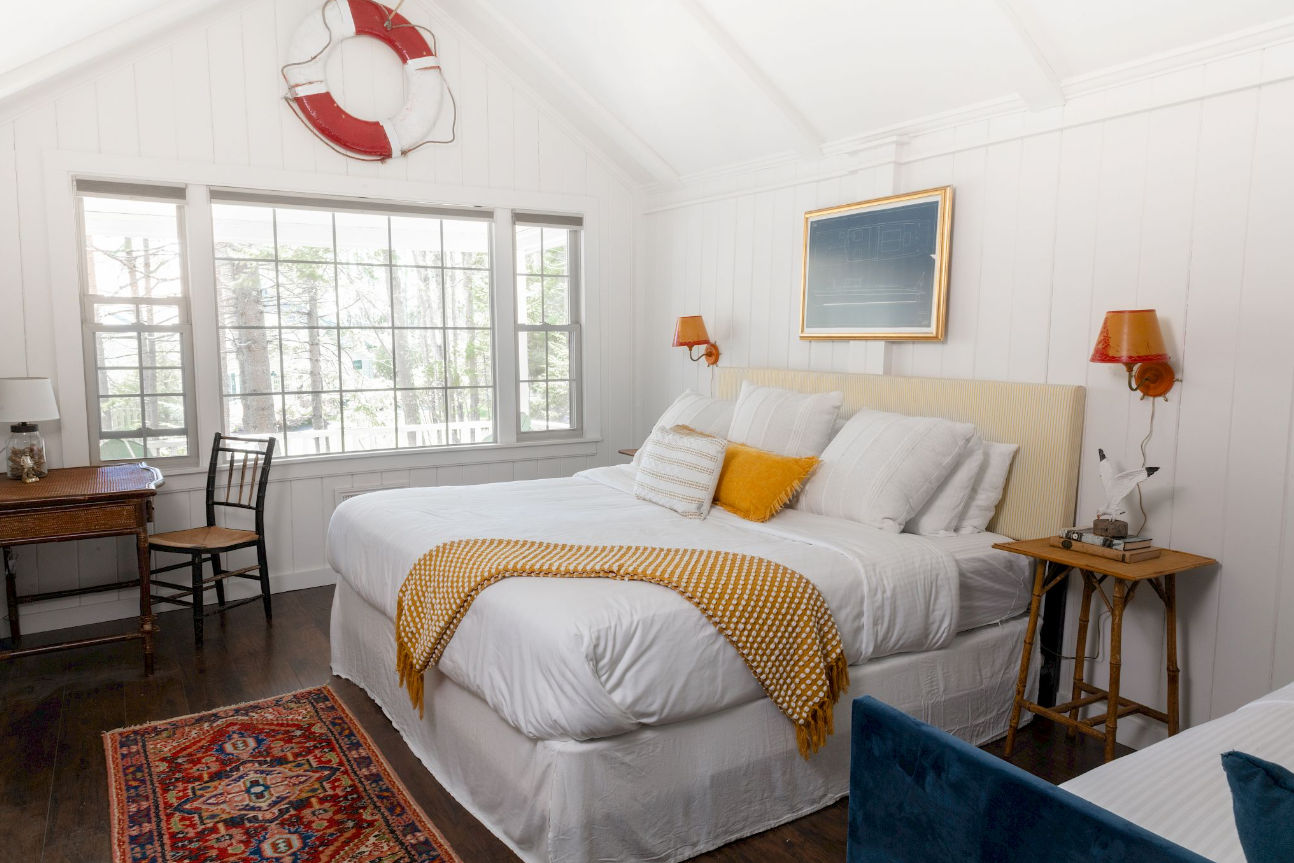 image Crisp linens and playful maritime accents offer a restful pause infused with classic Maine cottage charm.