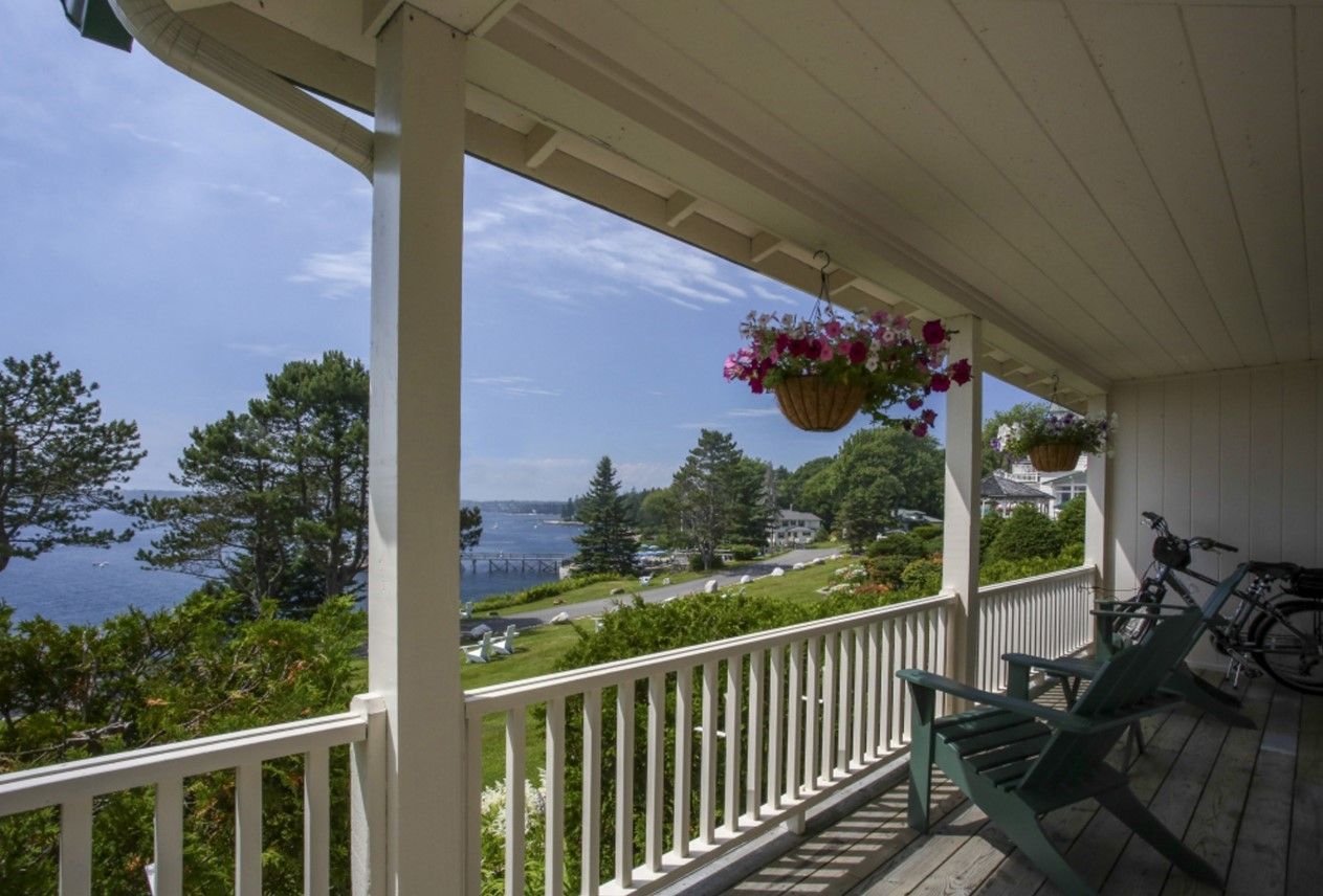 image Take your morning coffee outdoors, where hanging blooms and salty breezes welcome a slower pace.