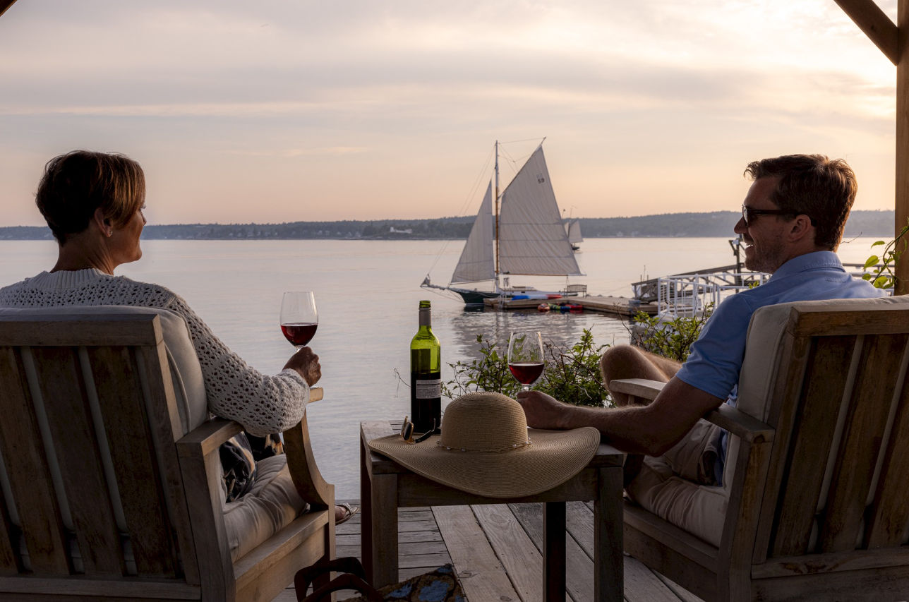 image Watch the day slip into evening with a glass in hand and the harbor aglow—moments like this were made to be savored.