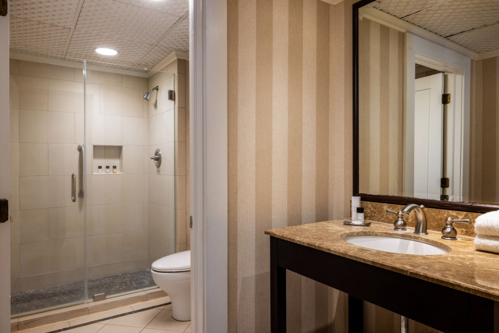 image A pristine bathroom space that promises a revitalizing routine with its sleek design and modern comforts.