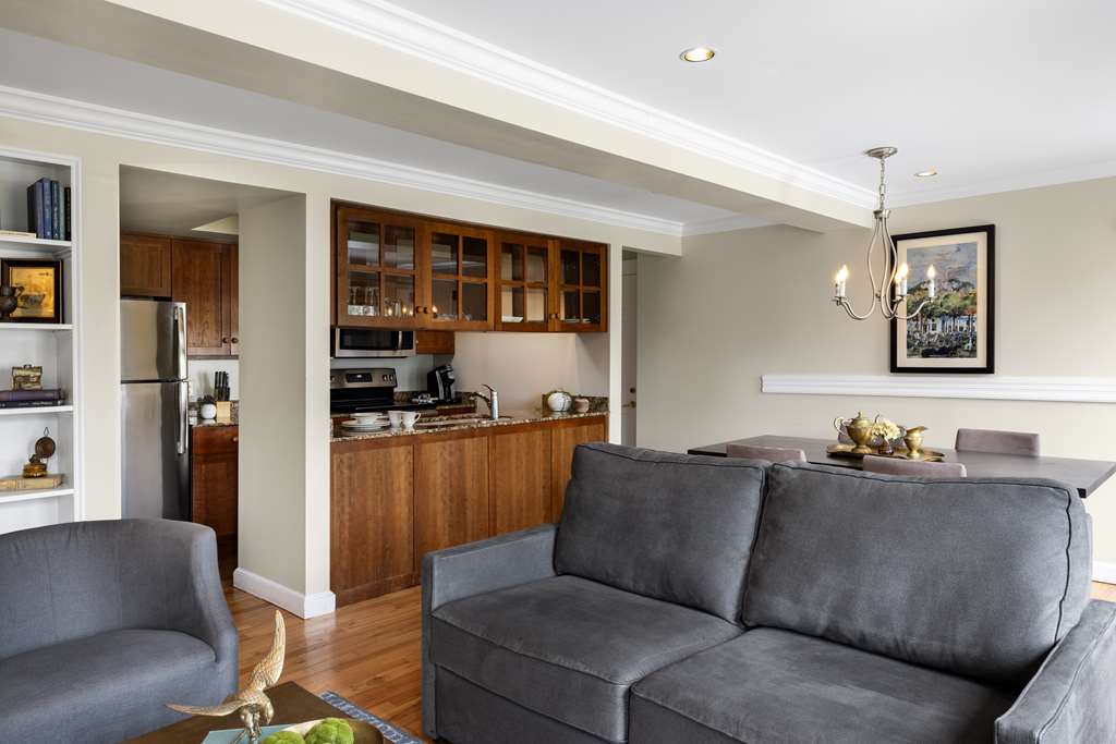 image The cozy living area features stylish grey sofas, a dining table, and a well-equipped kitchen, creating a welcoming space perfect for relaxation and gatherings.