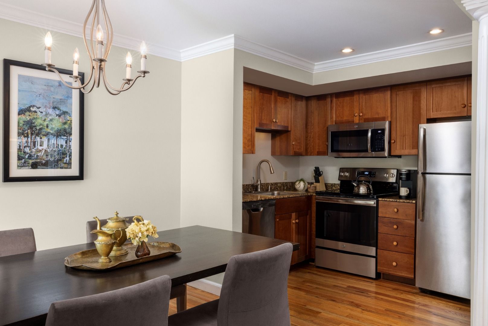 image The full kitchen offers modern appliances and warm wooden cabinetry, paired with a charming dining space that invites you to enjoy home-cooked meals amidst a cozy atmosphere.