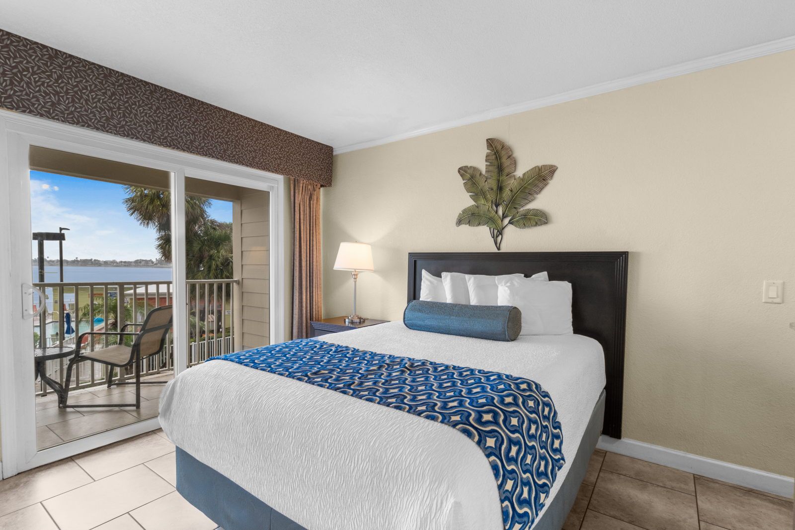 image Relax in comfort with your own queen bed and access to the balcony for fresh breezes.