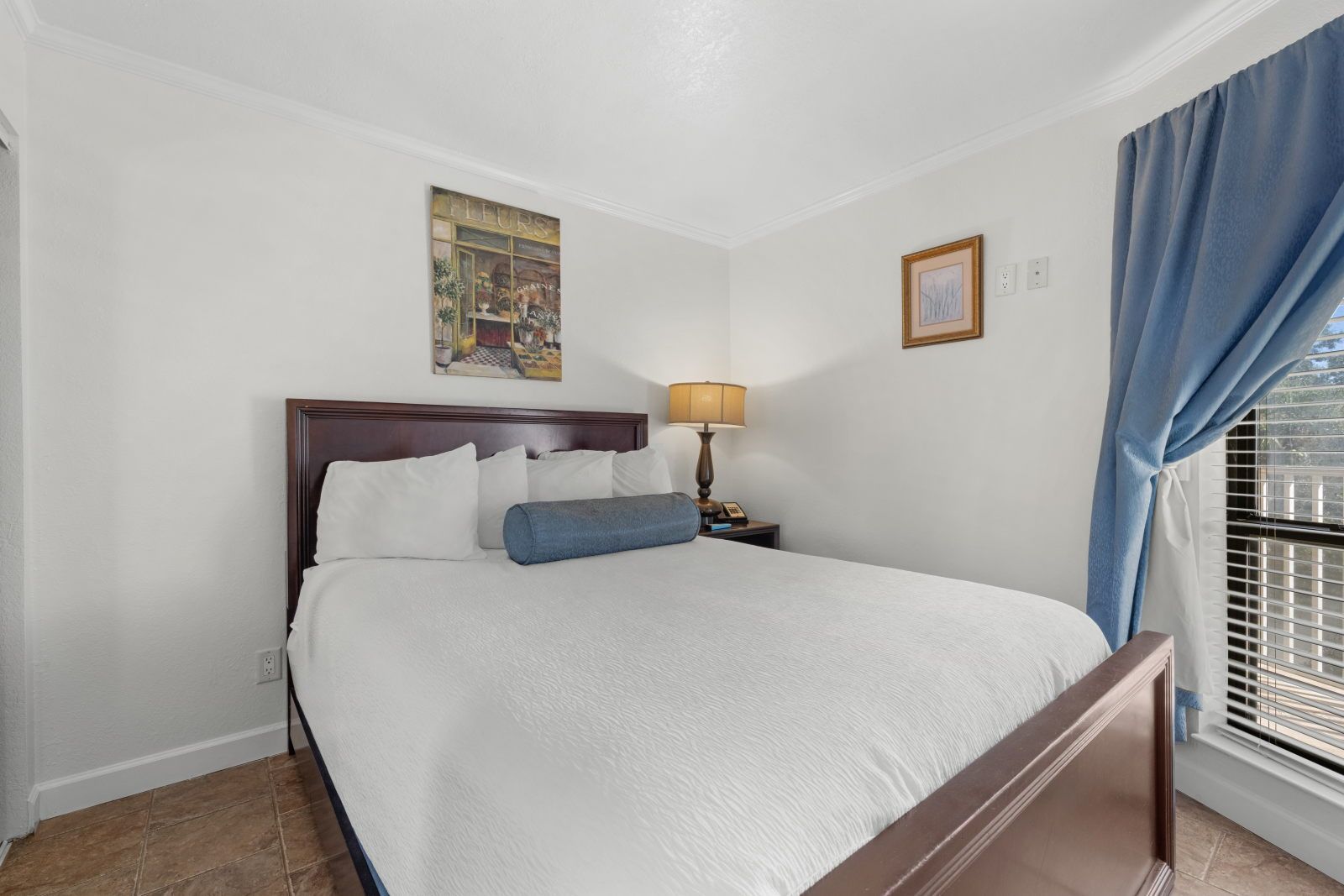 image Unwind in the cozy queen bed dressed in plush linens, perfect for restful nights.
