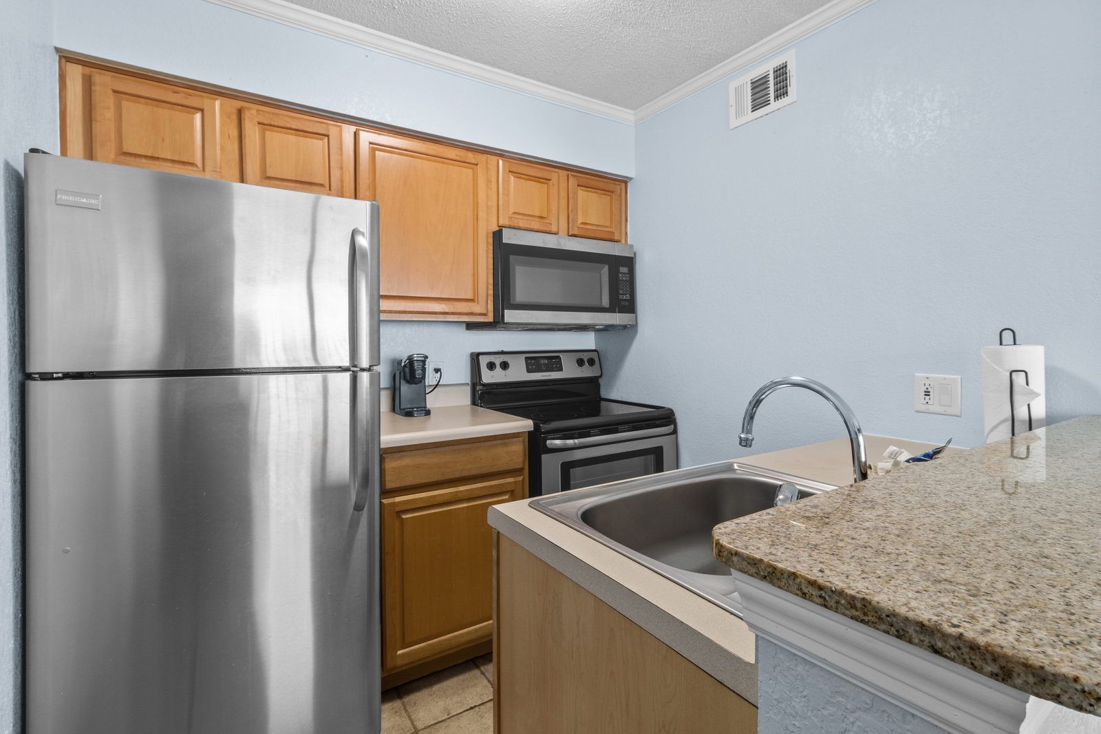 image Whip up meals in this well-equipped kitchen, complete with modern appliances and granite countertops.