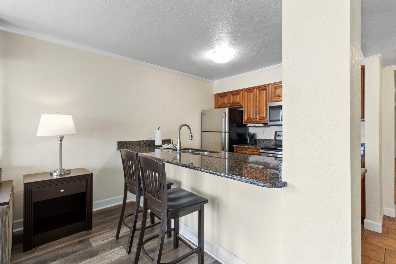 image Enjoy morning coffee at the stylish breakfast bar, complete with granite countertops and polished wood details.