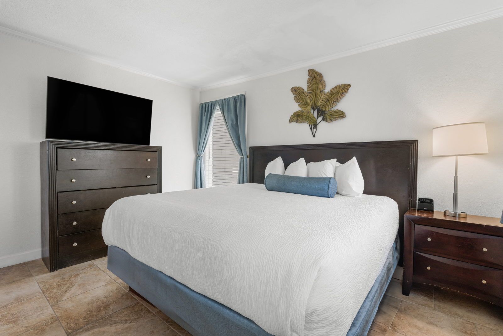 image Bright and inviting, this cozy bedroom promises comfort with stylish decor and a plush bed.