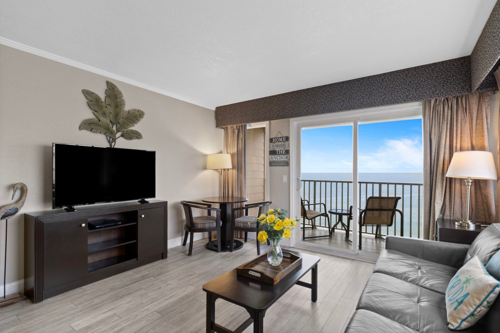 image Relax in the inviting living area, where coastal decor meets comfort and a view awaits beyond the sliding door.