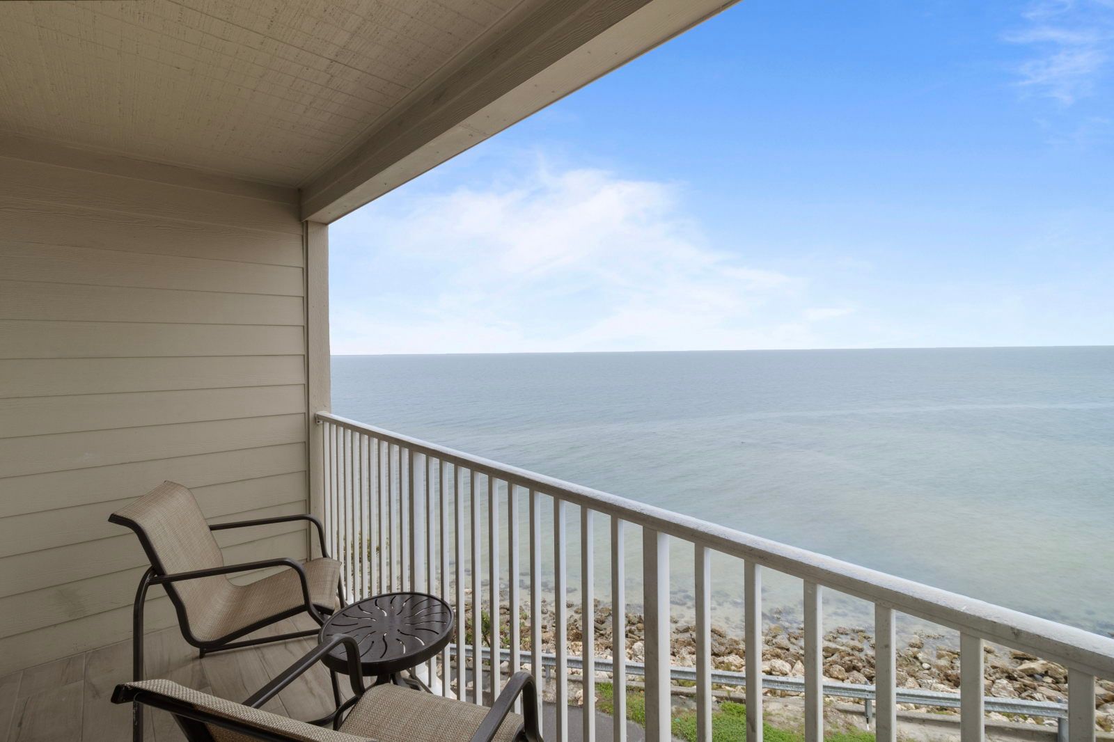 image Breathe in the refreshing ocean air from your private balcony, perfect for enjoying morning coffee.