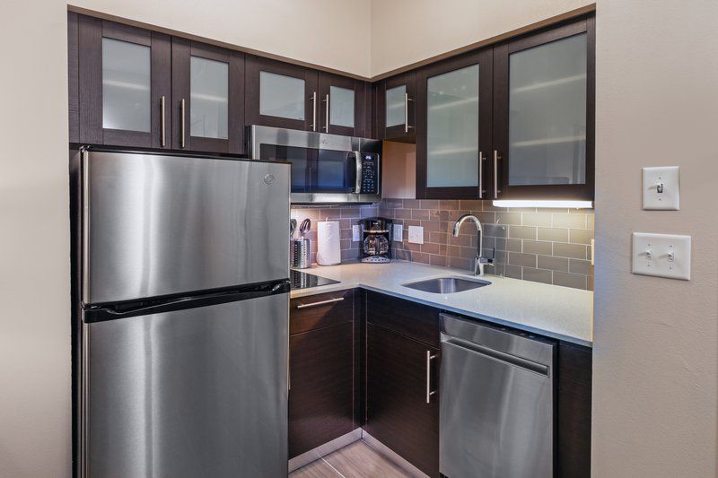 image Cook up a storm in this fully-equipped kitchen, featuring stainless appliances and sleek cabinetry.