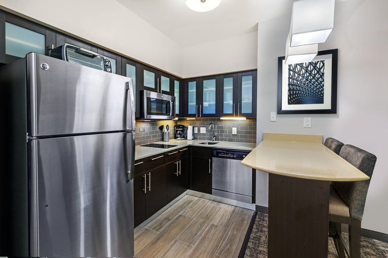image Cook up your favorite meals in this modern kitchen, featuring sleek appliances and ample counter space.