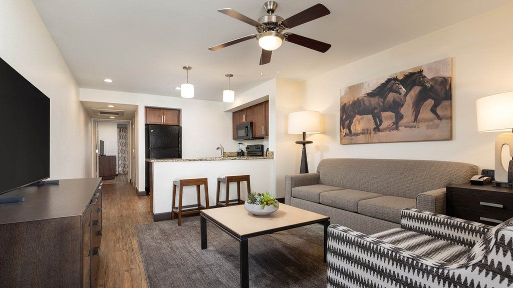 image Unwind in the open living space, featuring a comfortable sofa, flat-screen TV, and inviting decor.