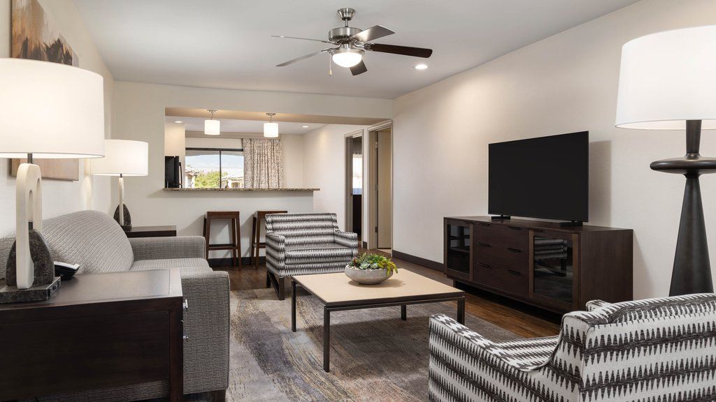 image Spacious living area with stylish furnishings and a flat-screen TV, ideal for lounging or entertaining.