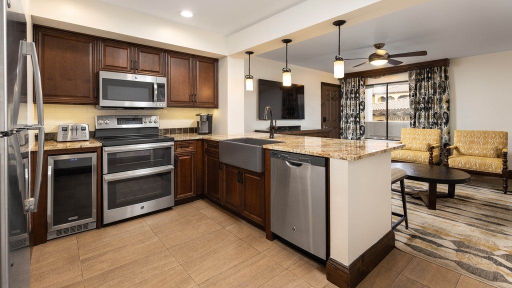 image Cook and gather in this beautiful kitchen, complete with stainless appliances and inviting seating.
