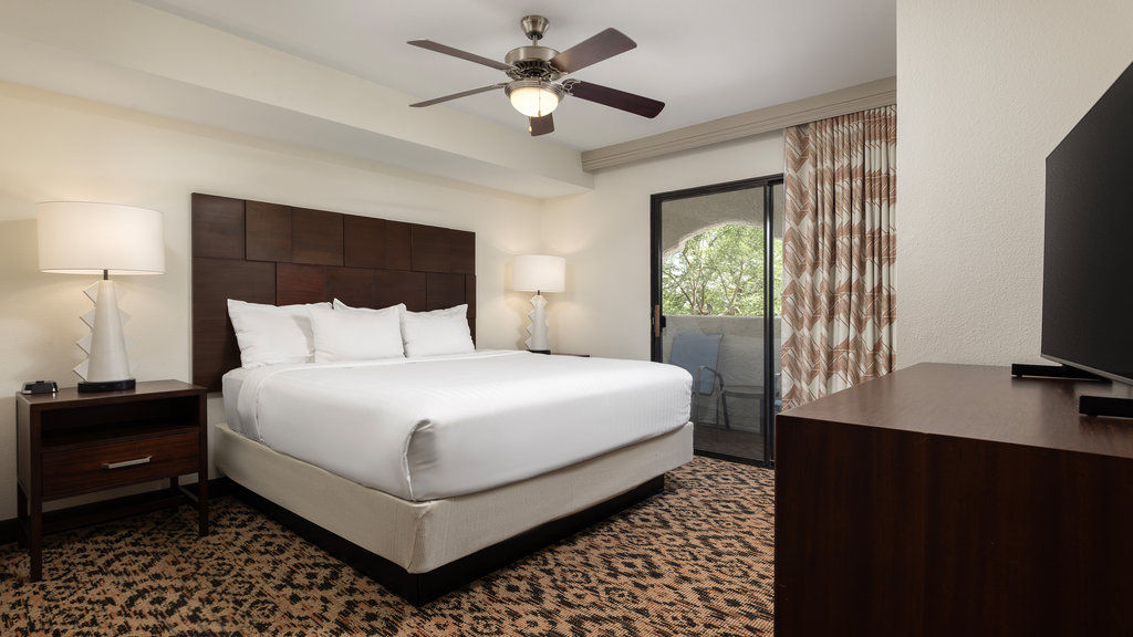 image Unwind in this cozy room with a plush king-size bed and easy access to your private balcony.