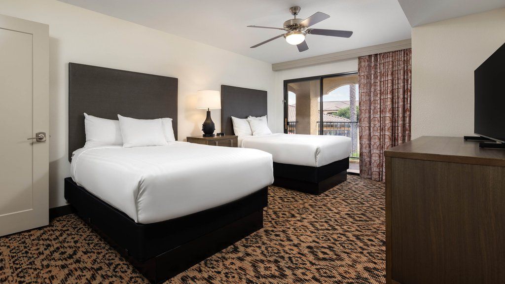 image Enjoy a restful night in this beautifully appointed room with two cozy beds and a view of the outdoors.