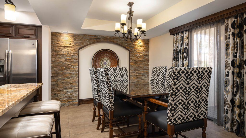 image Gather around the elegant dining table, surrounded by unique decor and cozy lighting for memorable meals.