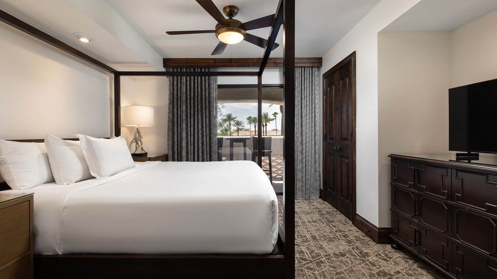 image Sink into a plush king-size bed adorned with soft linens and accentuated by warm lighting.