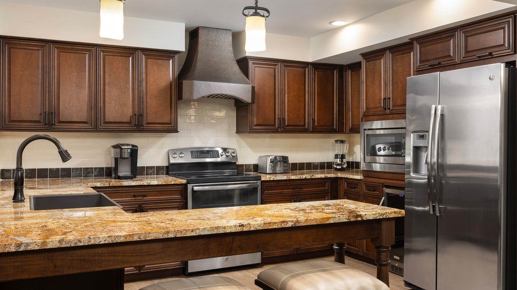 image Cook up a feast in a modern kitchen featuring rich wood cabinetry and sleek stainless steel appliances.