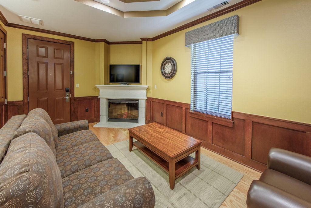 image Enjoy the warm ambiance of the living area, featuring a fireplace and comfy seating for leisurely moments.