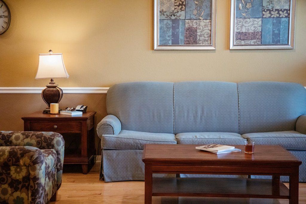 image Unwind on the cozy sofa beside warm lighting and tasteful decor, creating an inviting atmosphere for your stay.