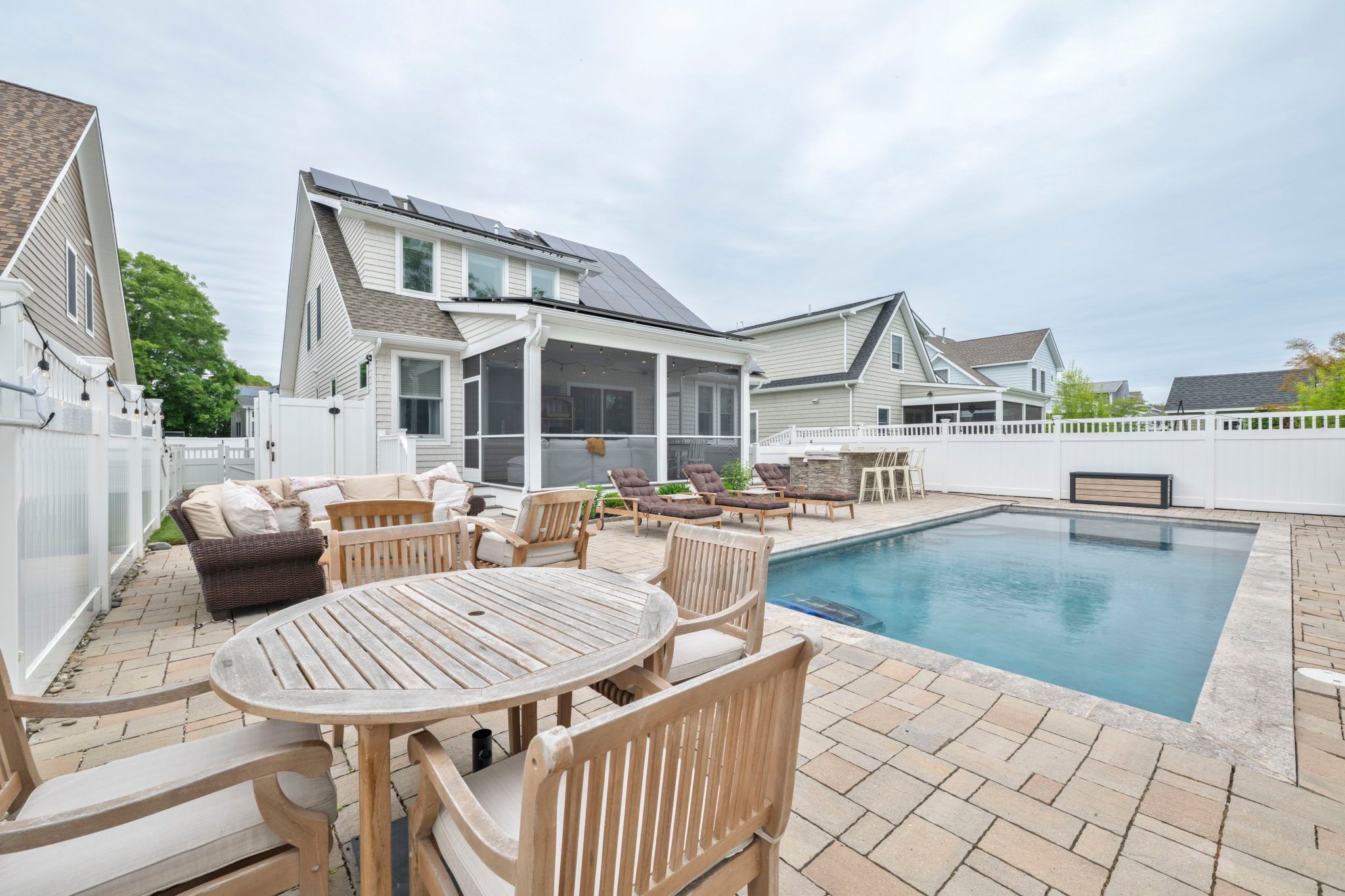 image Relax by the saltwater pool, surrounded by cozy seating for sun-soaked days and balmy evenings.