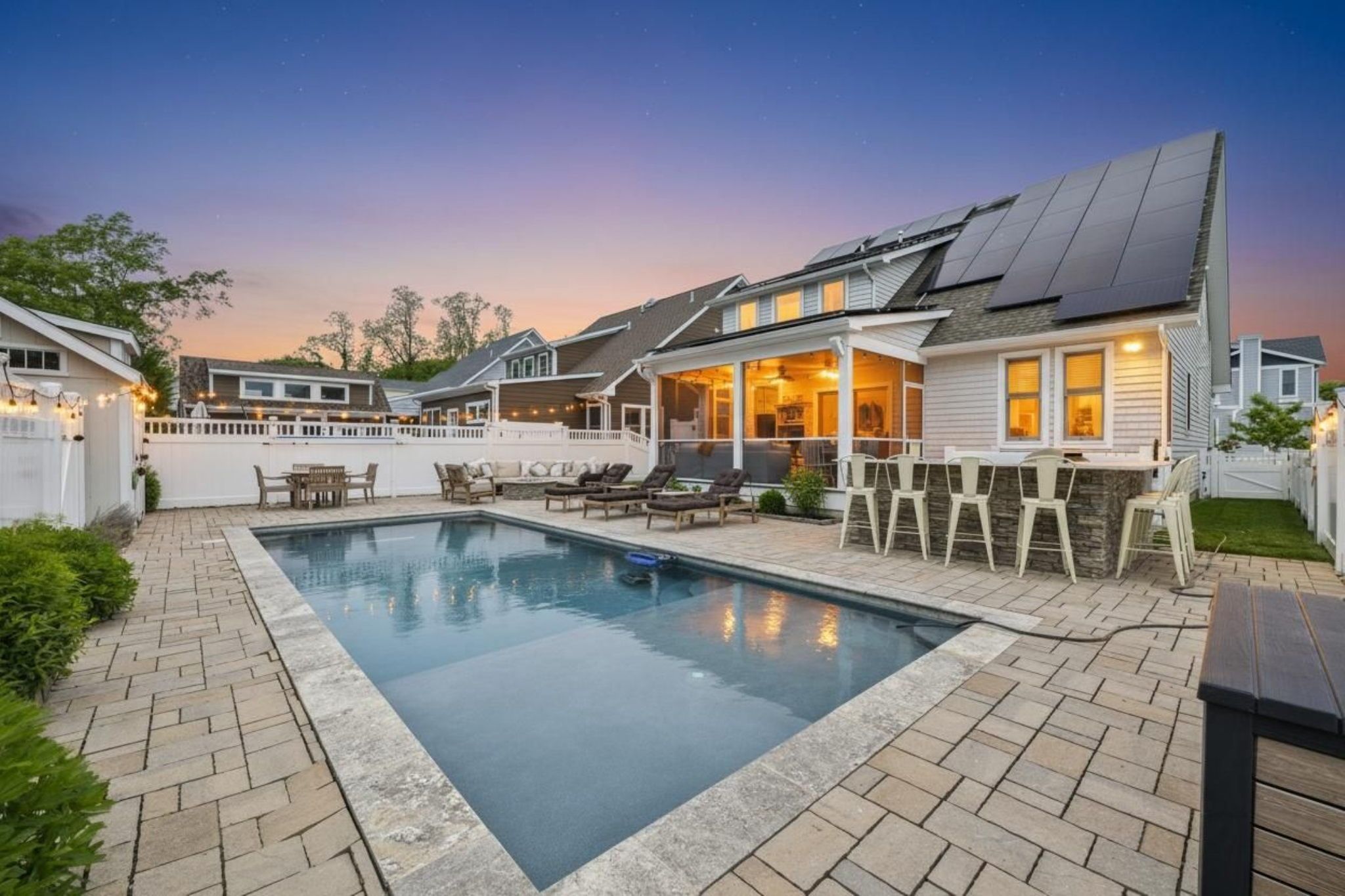image Dive into relaxation with the sun-drenched pool and shaded lounging area, ideal for soaking up the summer vibes.