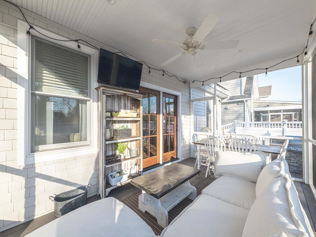 image Relax on the plush sofa under the fan, enjoying the cozy comfort of your outdoor retreat.