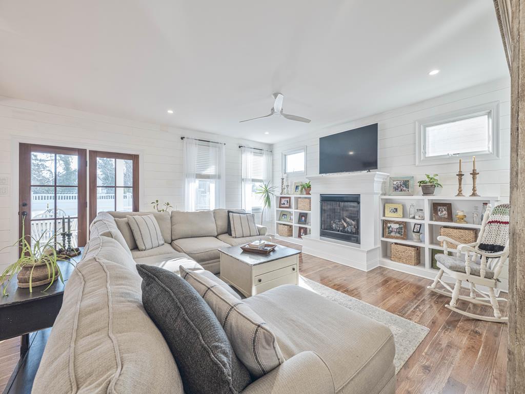 image Enjoy cozy evenings by the fireplace, surrounded by natural light and inviting decor for a warm ambiance.