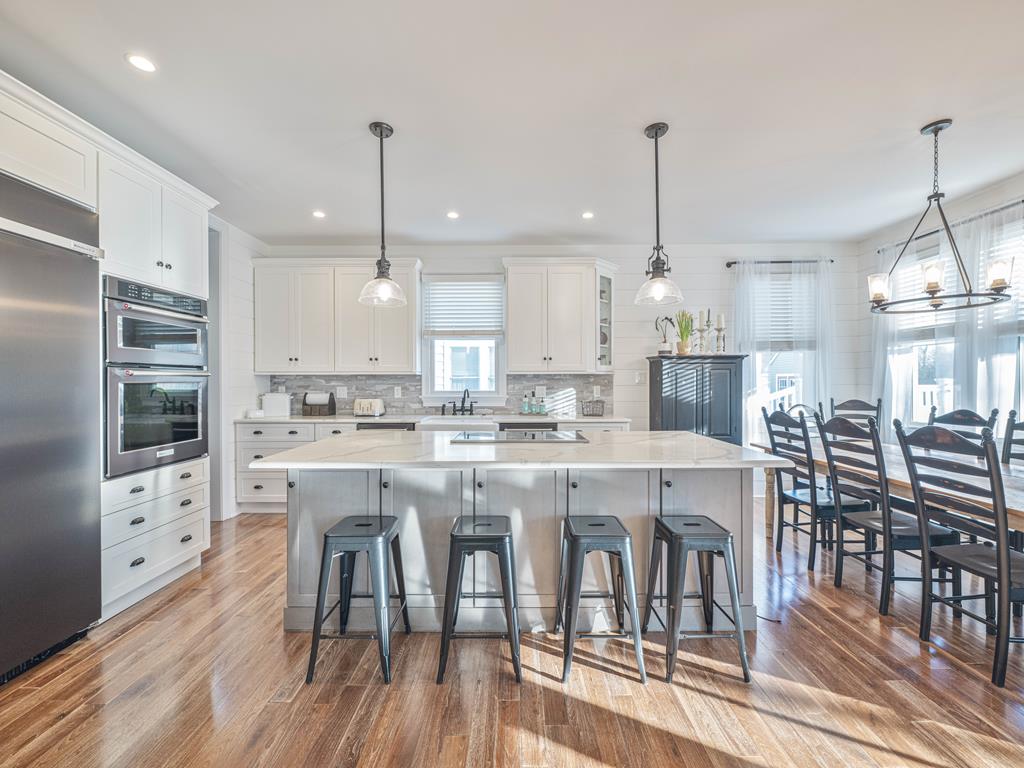 image Gather around the spacious kitchen island, perfect for casual breakfasts and late-night chats.