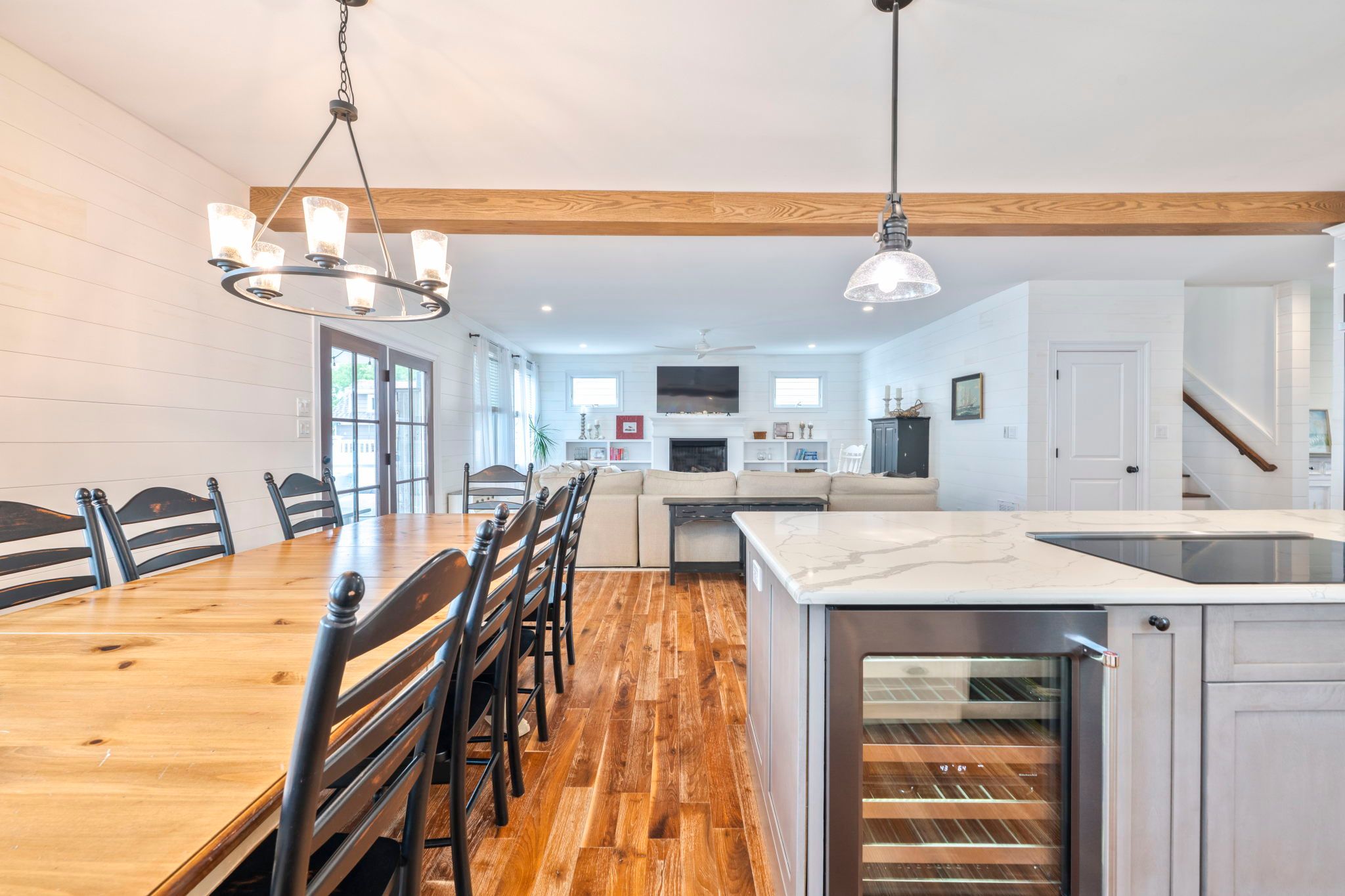 image Bask in the warm glow of the dining area, leading to a comfy living space with a cozy ambiance.