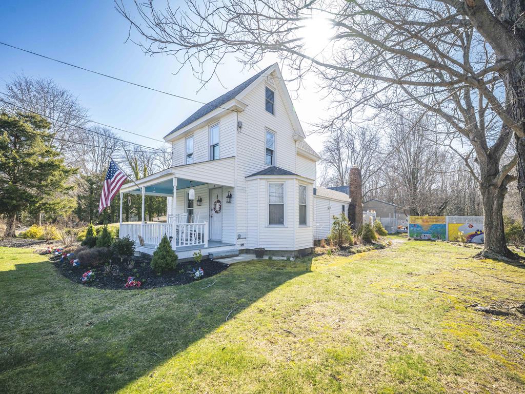 image Side view of the house highlights the manicured flower beds along the front.