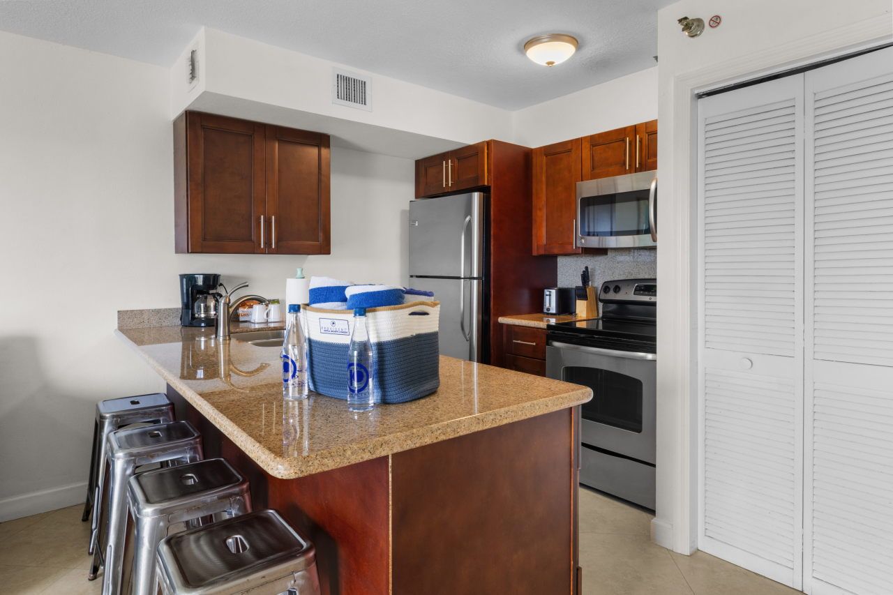 image Brew your morning coffee and enjoy island vibes at this inviting kitchen bar.