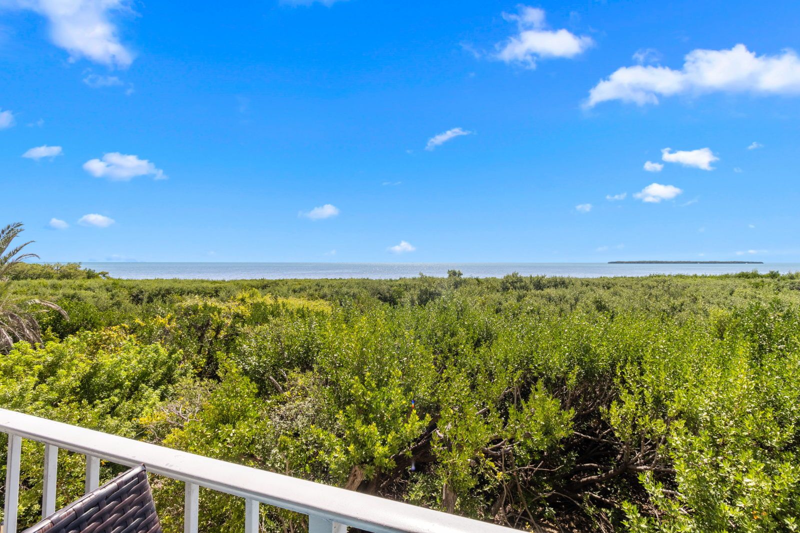 image Breathe in the fresh ocean air from your private balcony overlooking lush greenery.