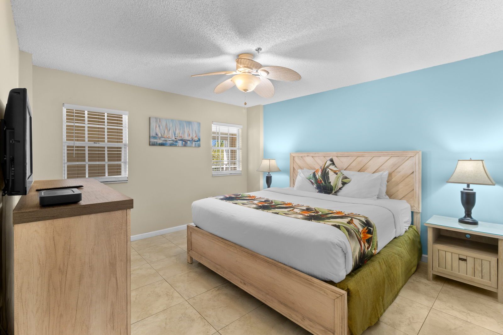 image Relax in a tastefully designed bedroom featuring a king-size bed and soft, tropical accents.