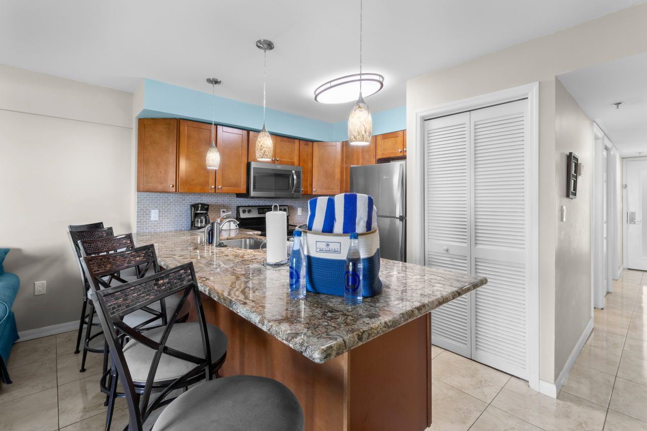 image Gather around the spacious kitchen bar, a perfect spot for snacks and drinks before venturing out.