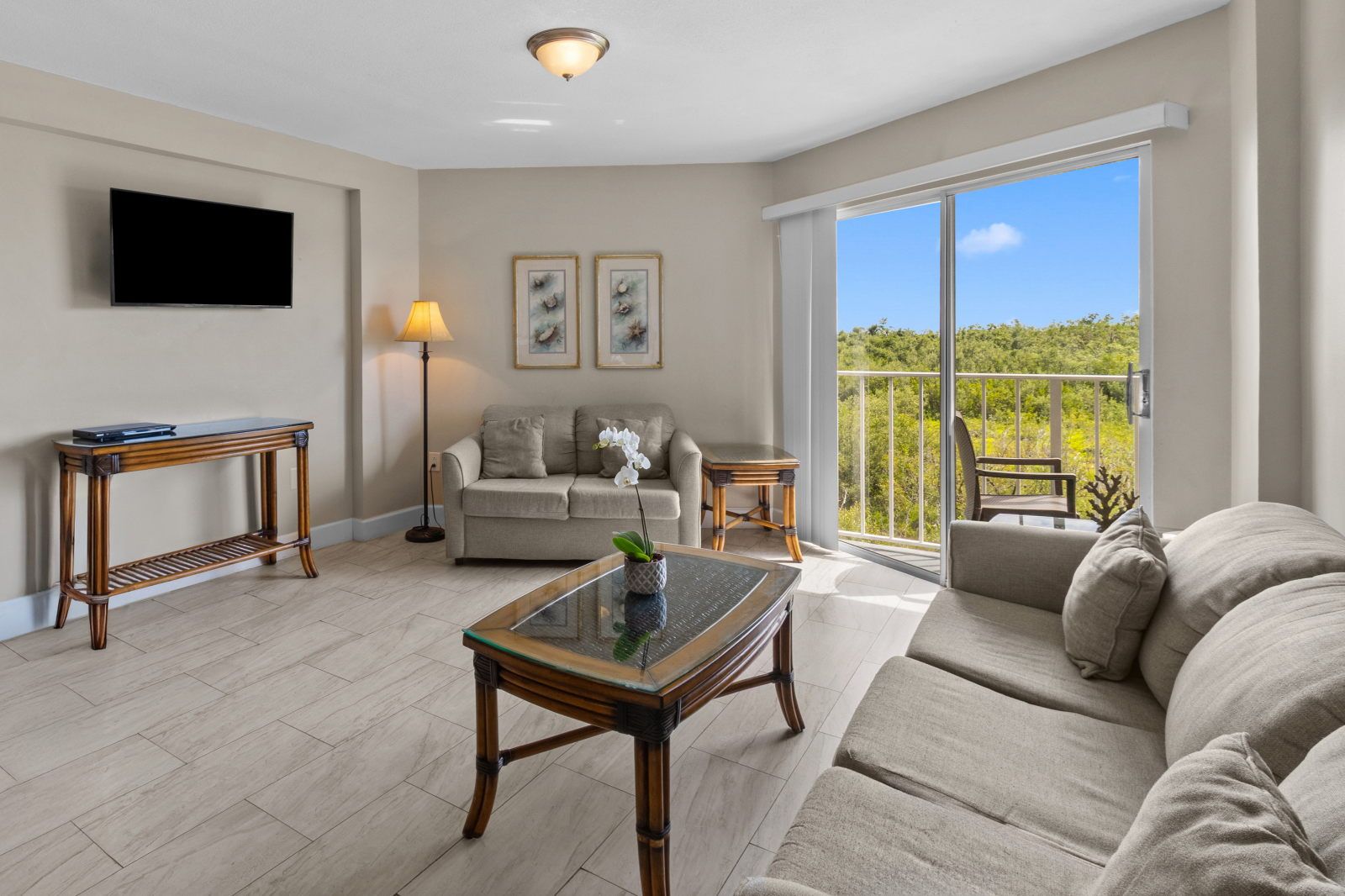 image Relax in a spacious living area, complete with plush seating and a sunny view out to nature.
