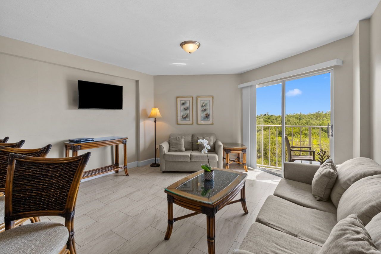image Relax in a sunlit living area, featuring chic decor and inviting couches, perfect for unwinding.